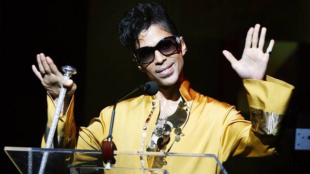 Musician Prince gestures on stage during Apollo Theatre's 75th anniversary gala in New York