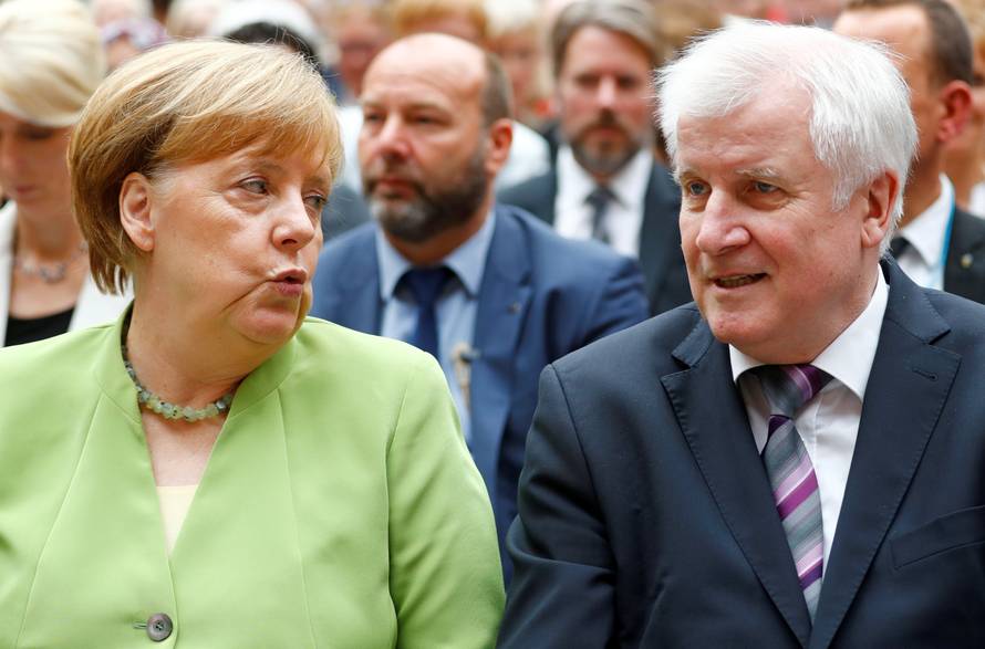 FILE PHOTO: German Chancellor Merkel and German Interior minister Seehofer attend an event to commemorate victims of displacement in Berlin