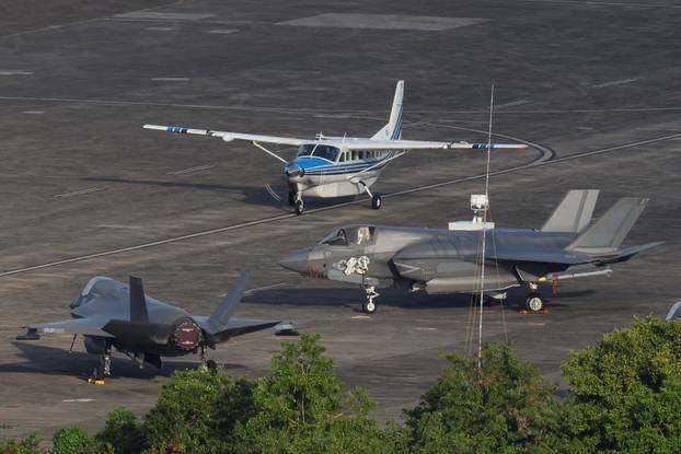 A small commercial aircraft taxis in front of U.S. Marine Corps F-35s parked on the apron at the former Roosevelt Roads Naval Station in Ceiba.