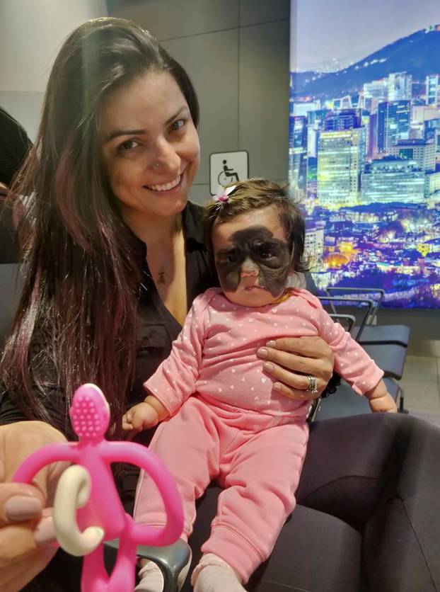 Carol Fenner holds her daughter Luna upon the arrival at Moscow