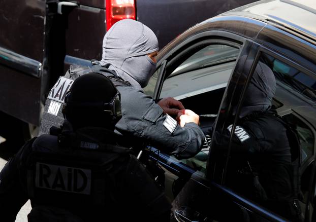 French police and members of special Police units RAID conduct an investigation after two Frenchmen were arrested in Marseille