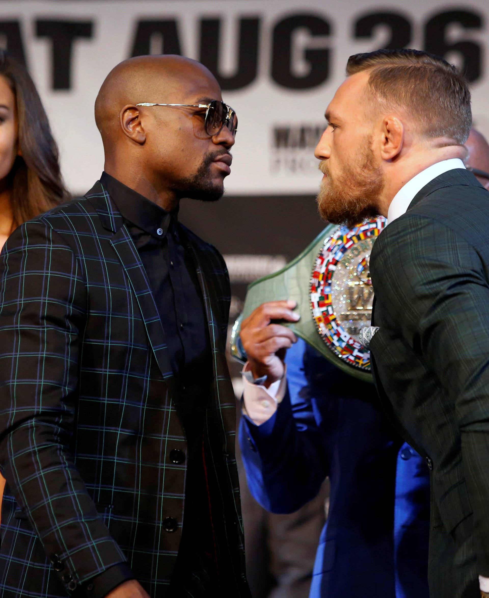 Conor McGregor (R) of Ireland stares down Floyd Mayweather Jr. of the U.S. during a news conference in Las Vegas