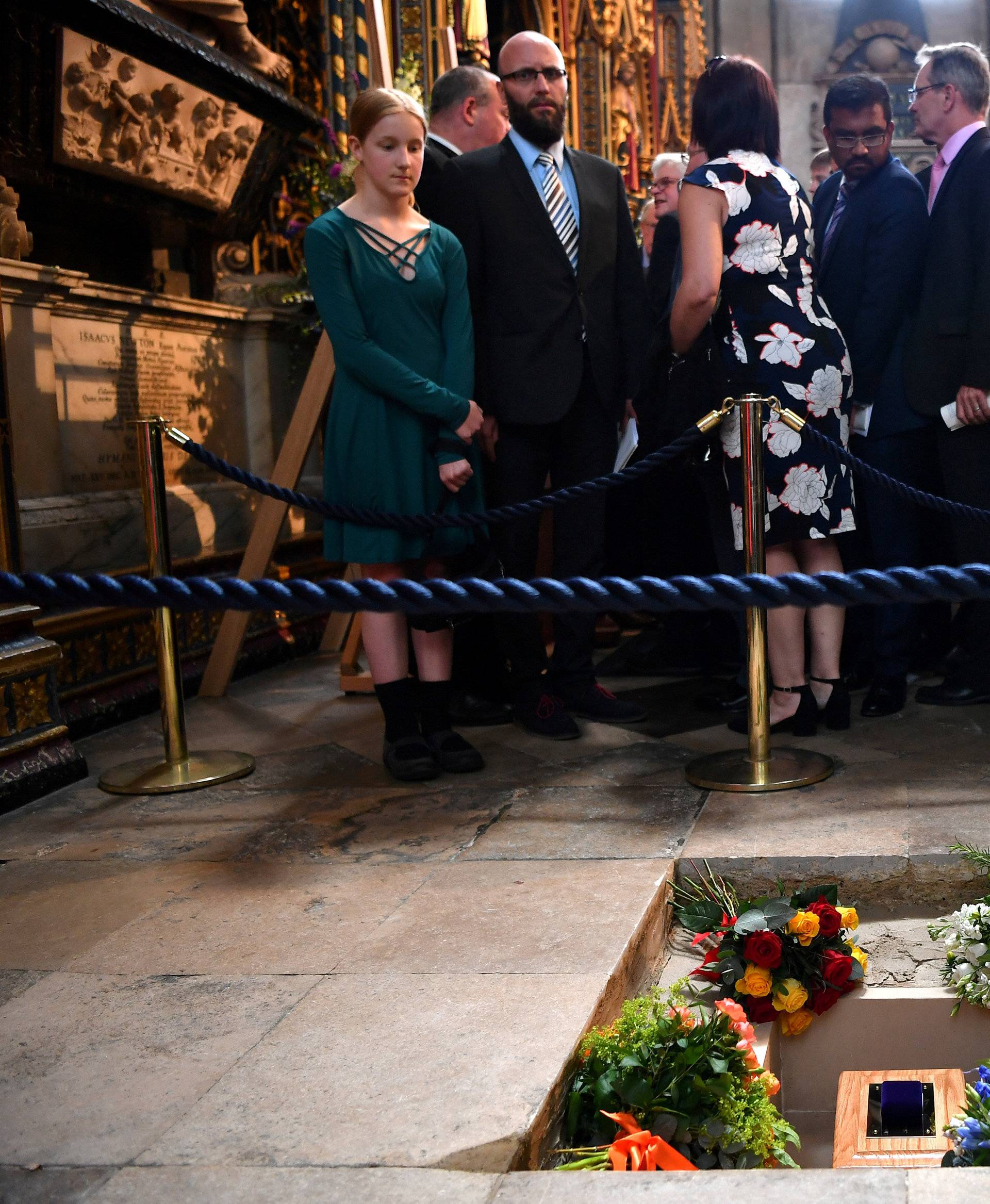 Members of the congregation file past the ashes of British scientist Stephen Hawking at the site of their interment in the nave of the Abbey church, during a memorial service at Westminster Abbey, in London