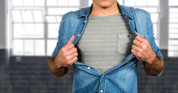 Midsection of man tearing shirt