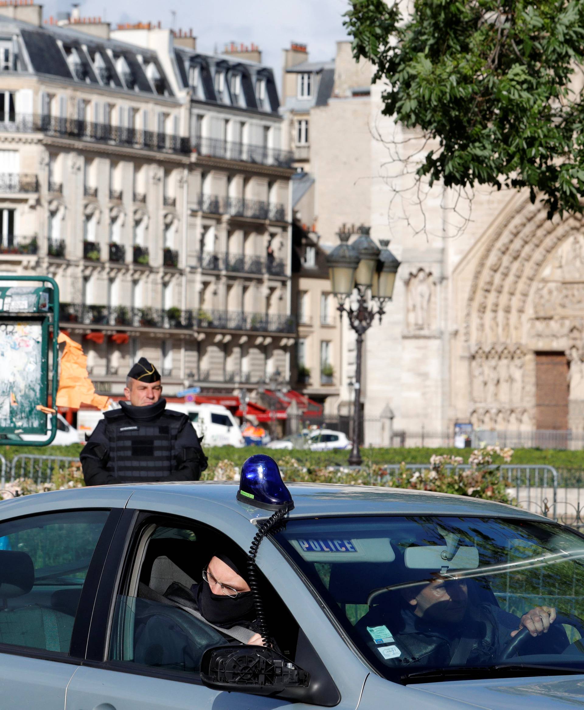 French police and gendarme stand at the scene of a shooting incident near the Notre Dame Cathedral in Paris