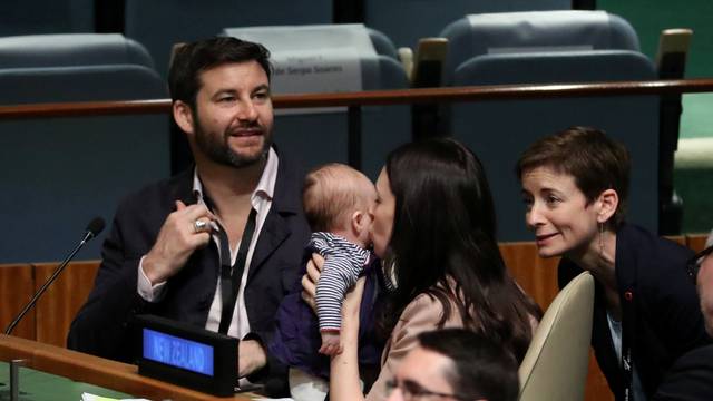 New Zealand Prime Minister Jacinda Ardern kisses her baby Neve before speaking at the Nelson Mandela Peace Summit during the 73rd United Nations General Assembly in New York