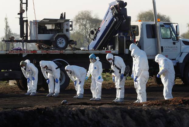 Forensic technicians work at the site where a fuel pipeline ruptured by suspected oil thieves exploded, in the municipality of Tlahuelilpan