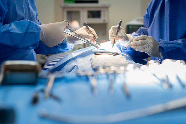 Asian doctor and an assistant in the operating room for surgical venous vascular surgery clinic in hospital.