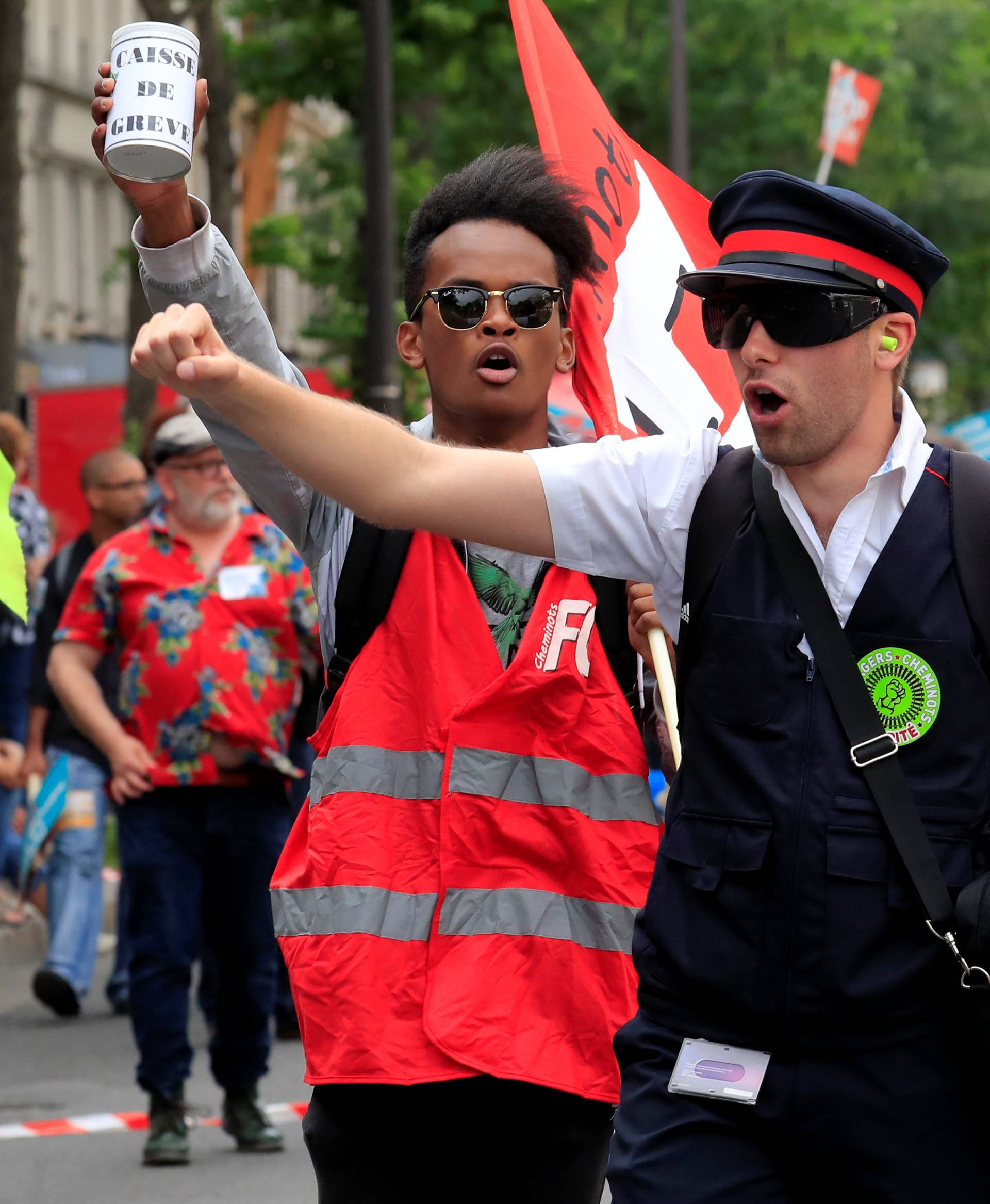 Protesters shout slogans during a demonstration by French unions and France Insoumise" (France Unbowed) political party to protest against government reforms, in Paris