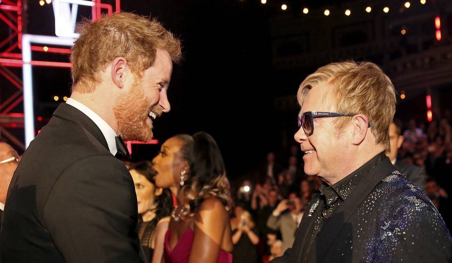 FILE PHOTO: Britain's Prince Harry greets Elton John after the Royal Variety Performance at the Albert Hall in London
