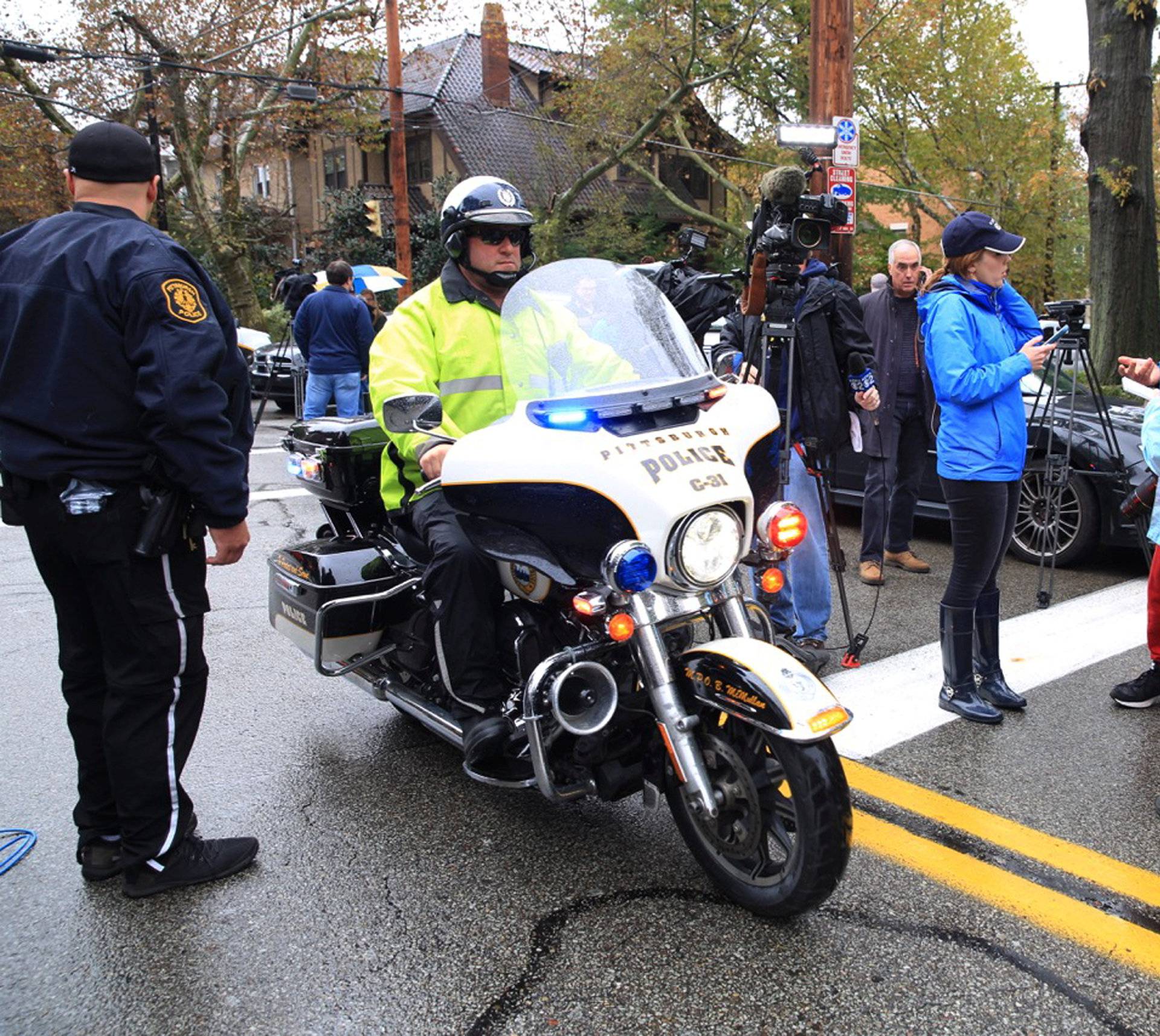 A police officer on motorcycle passes through a roadblock as he responds after a gunman opened fire at the Tree of Life synagogue in Pittsburgh