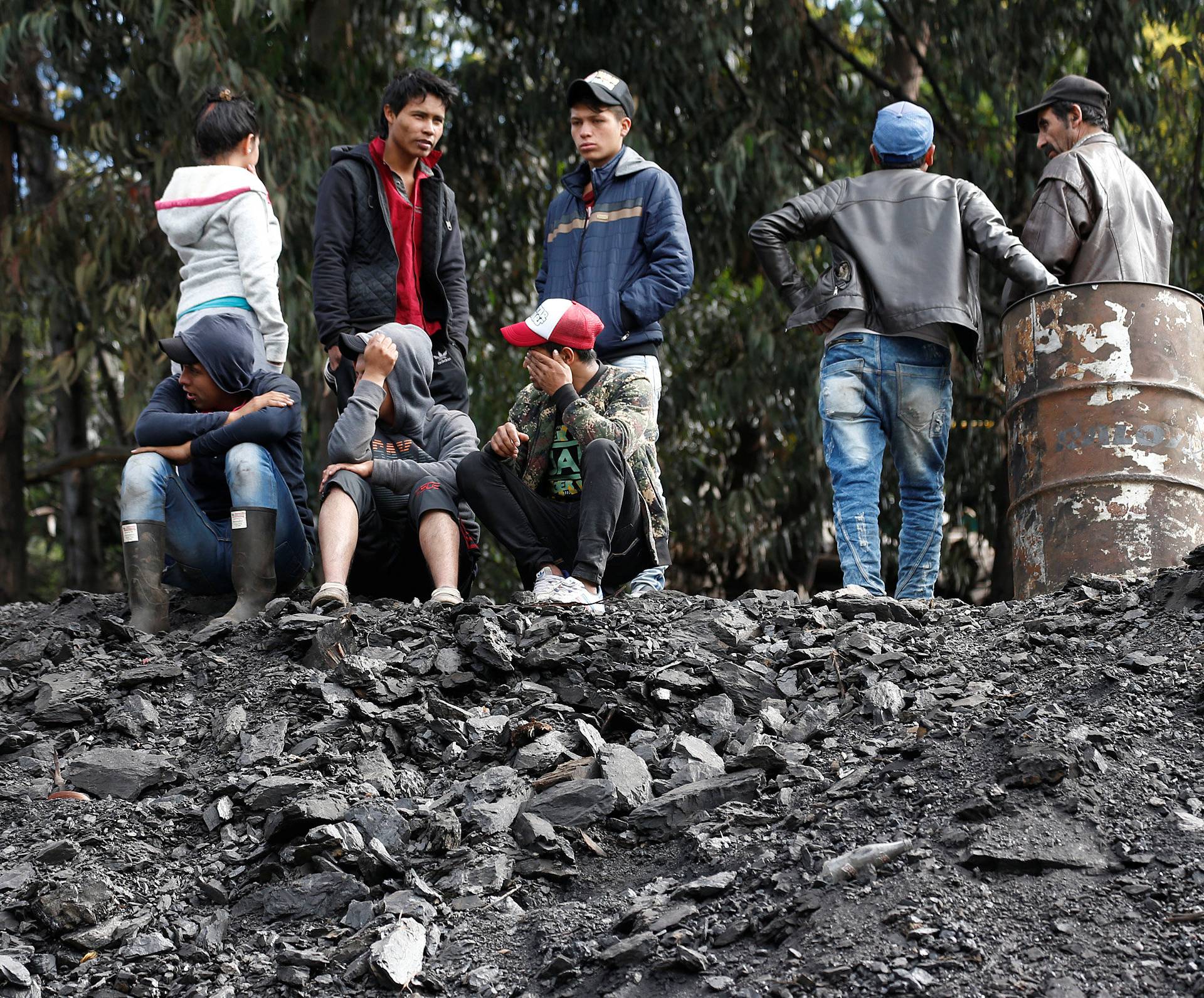 People wait for news of their missing relatives after an explosion at an underground coal mine on Friday, in Cucunuba