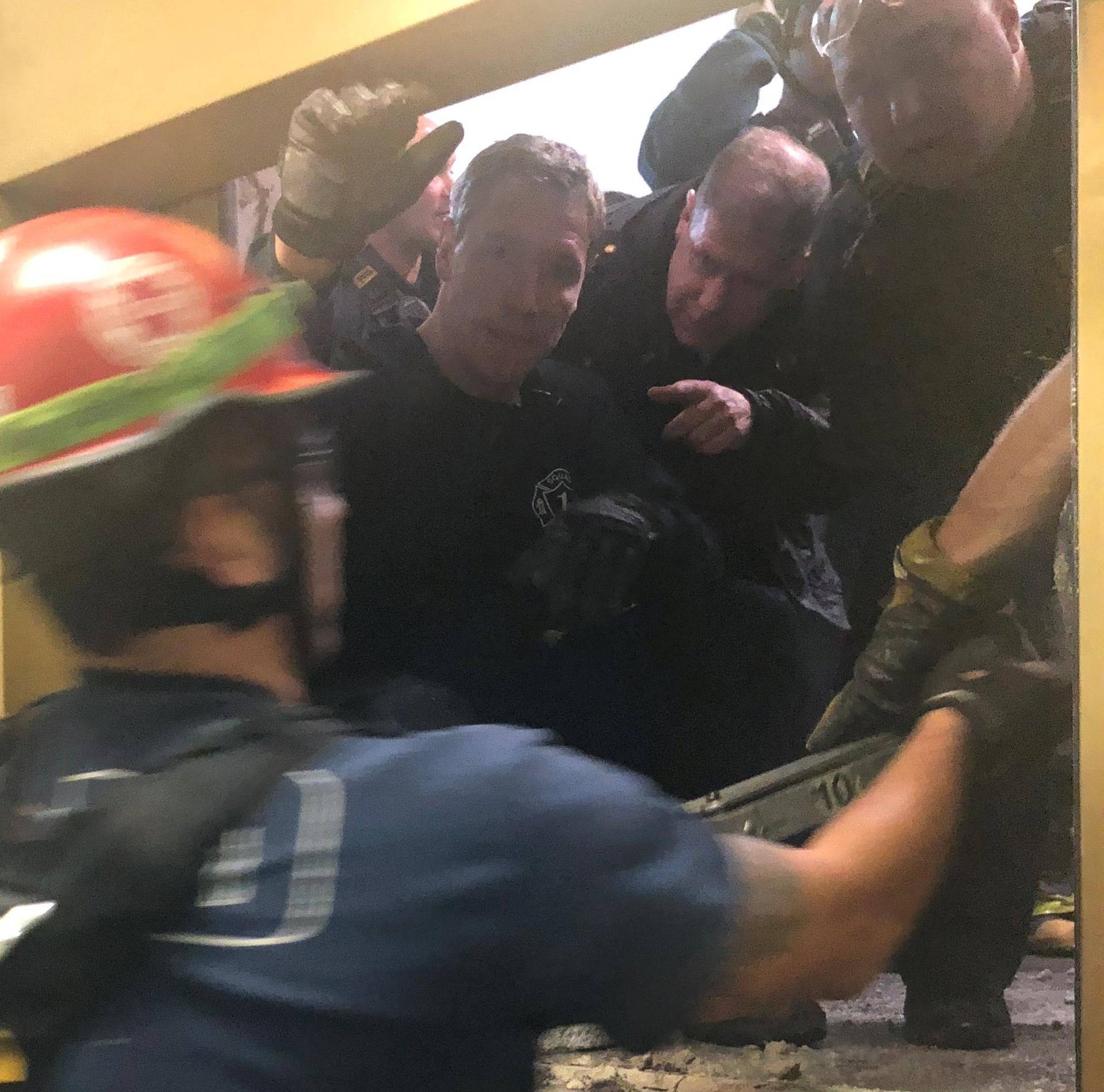 Rescue crew open the door to pull out six people trapped in an elevator of the 875 North Michigan Avenue building in Chicago