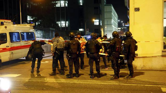 Police stand outside an Islamic center in central Zurich