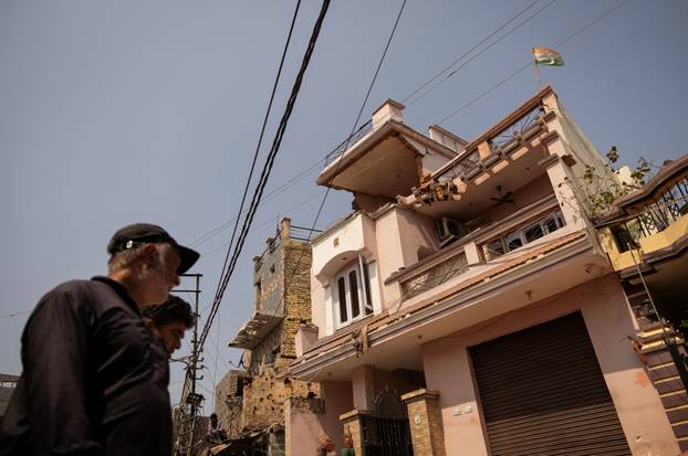An Indian flag is seen on top of a damaged house, following Pakistan's military operation against India, in Rehari