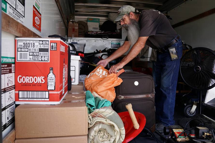 Mike Driver loads his possessions into a rental truck before Hurricane Florence comes ashore in Carolina Beach