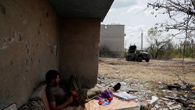A service member of pro-Russian troops takes a rest in Popasna