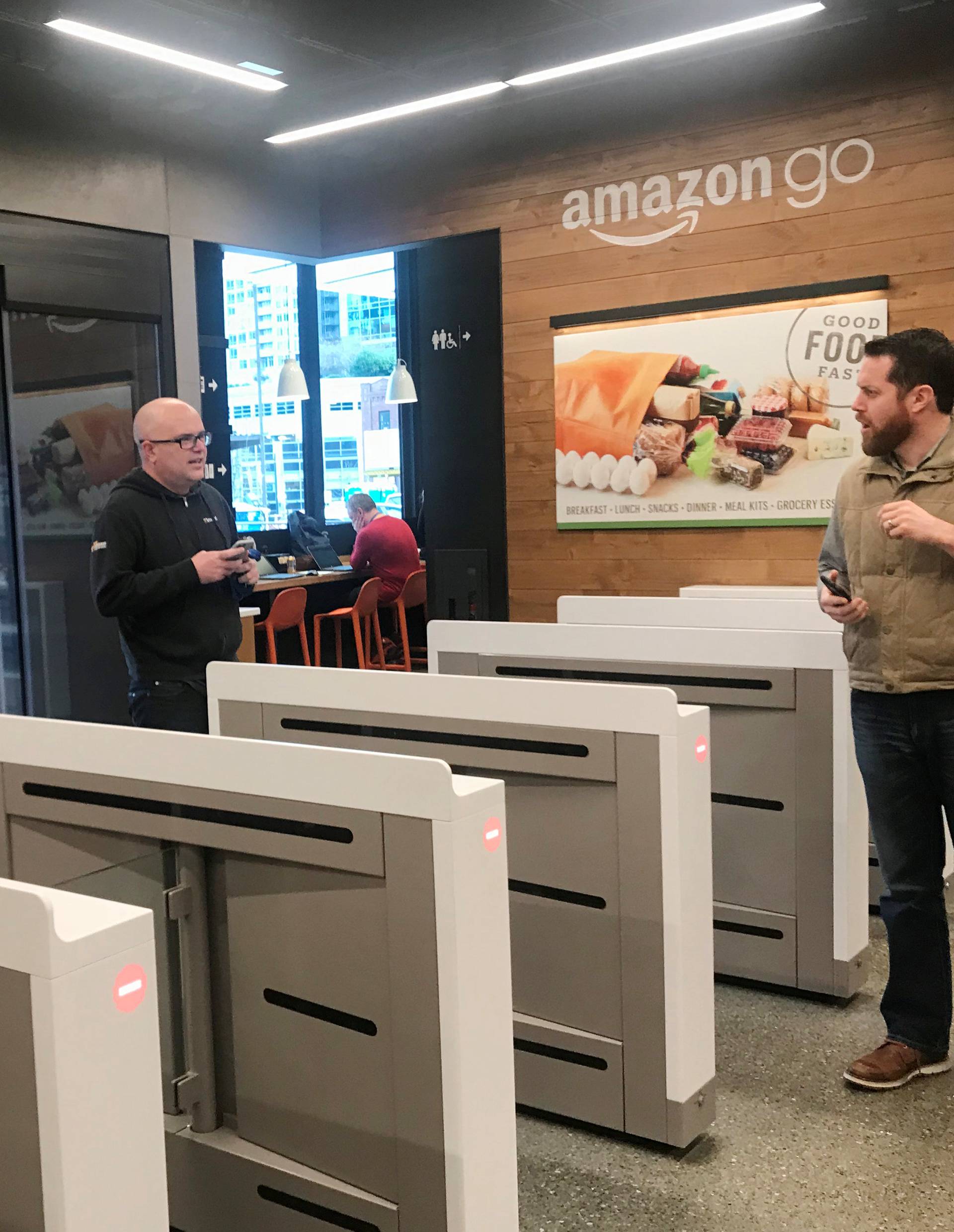 Shoppers enter the Amazon Go store located in Amazon's "Day 1" office building in Seattle