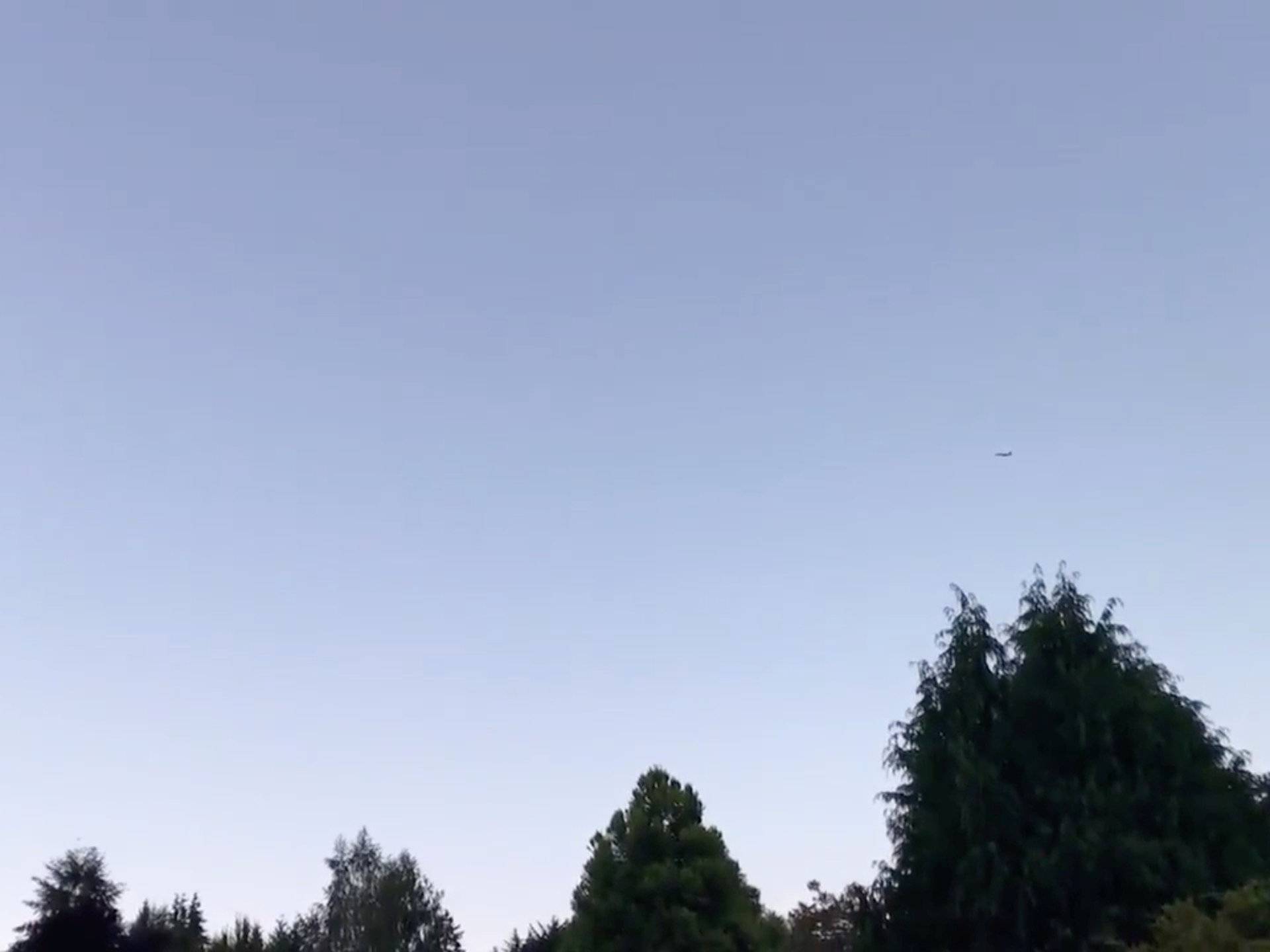 An F-15 jet flies overhead as it attempts to intercept a Horizon Air Bombardier Dash 8 Q400, which was reported to be hijacked, in Fircrest, Washington