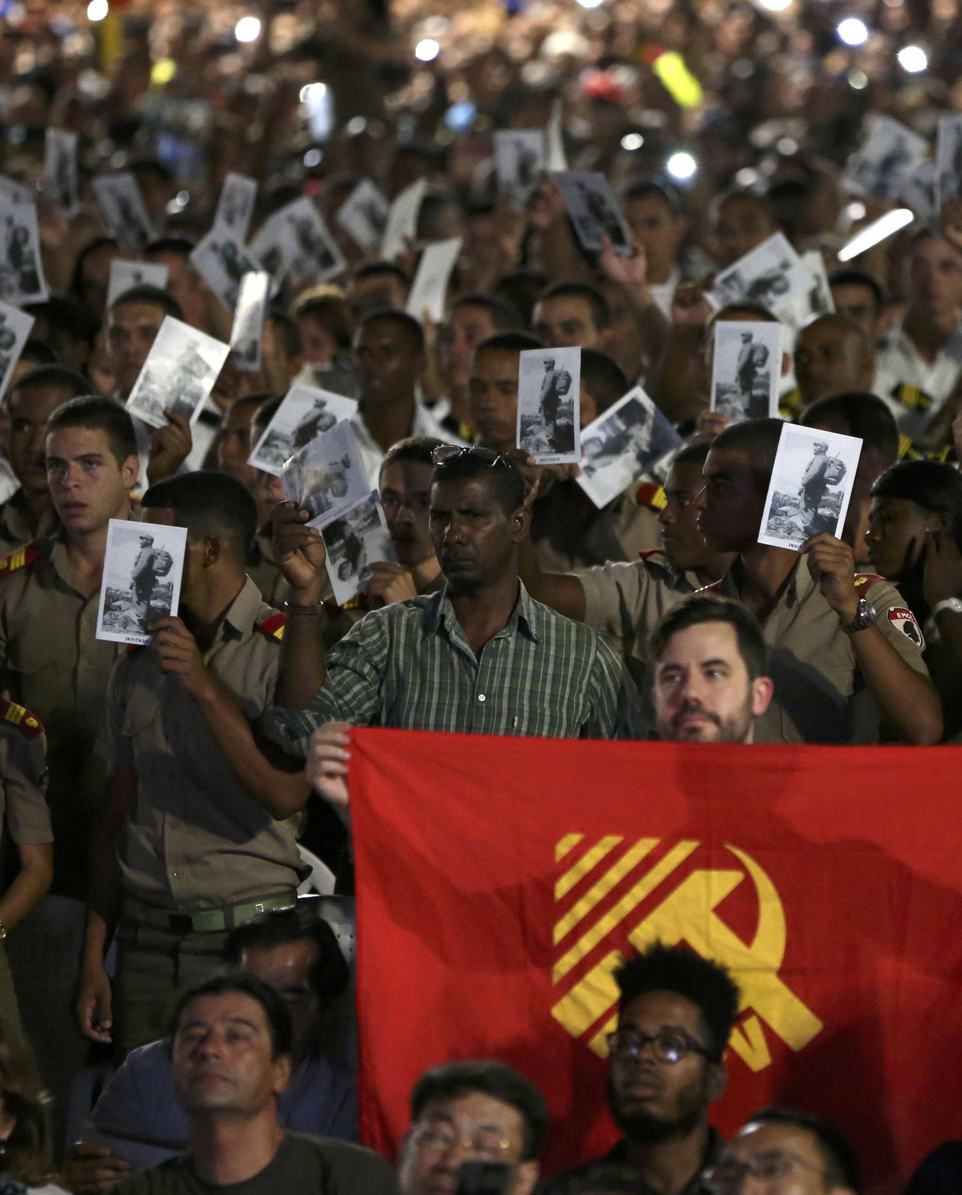 Cadets and sailors hold images of Cuba's late President Fidel Castro as they pay tribute in Havana