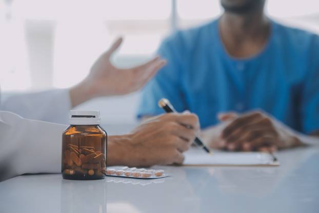 Doctor and patient discussing perfect health exam results. Frien