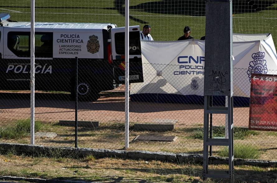 A body, believed to be of former Spanish Olympic skier Blanca Fernandez Ochoa, is surrounded by Spanish forensic technicians after being found at a mountain top in Cercedilla