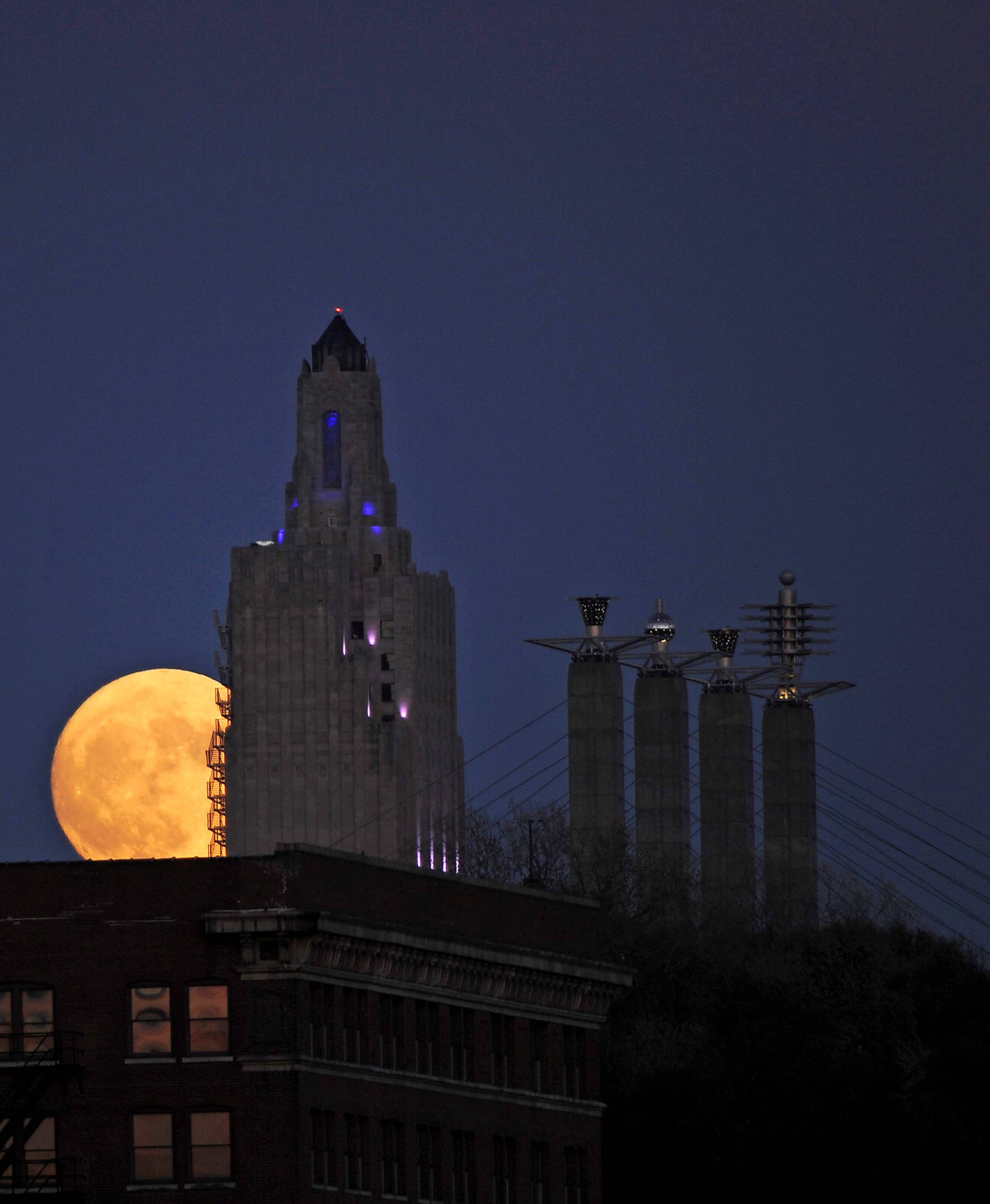 The "supermoon", the closest the moon comes to Earth since 1948, rises over the Power and Light building in downtown Kansas City, Missouri