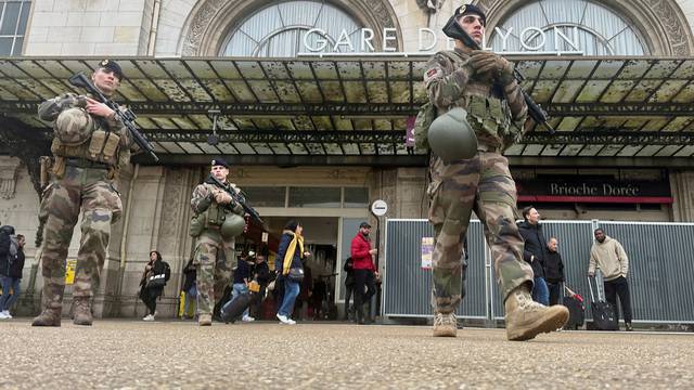 Officers secure the area at a rail station after a knife attack in Paris
