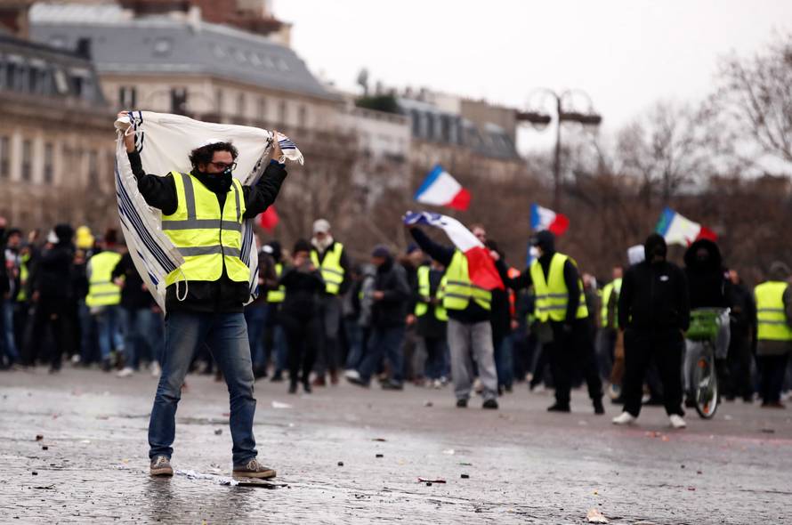 Protesters wearing yellow vests take part in a demonstration by the "yellow vests" movement near the Arc de Triomphe in Paris