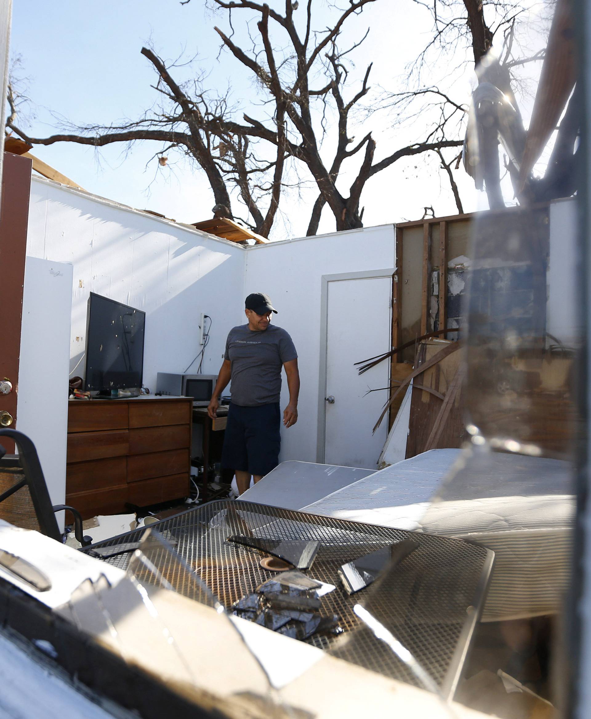 Carlos Pamias inspects his residence damaged by Hurricane Michael in Parker, Florida