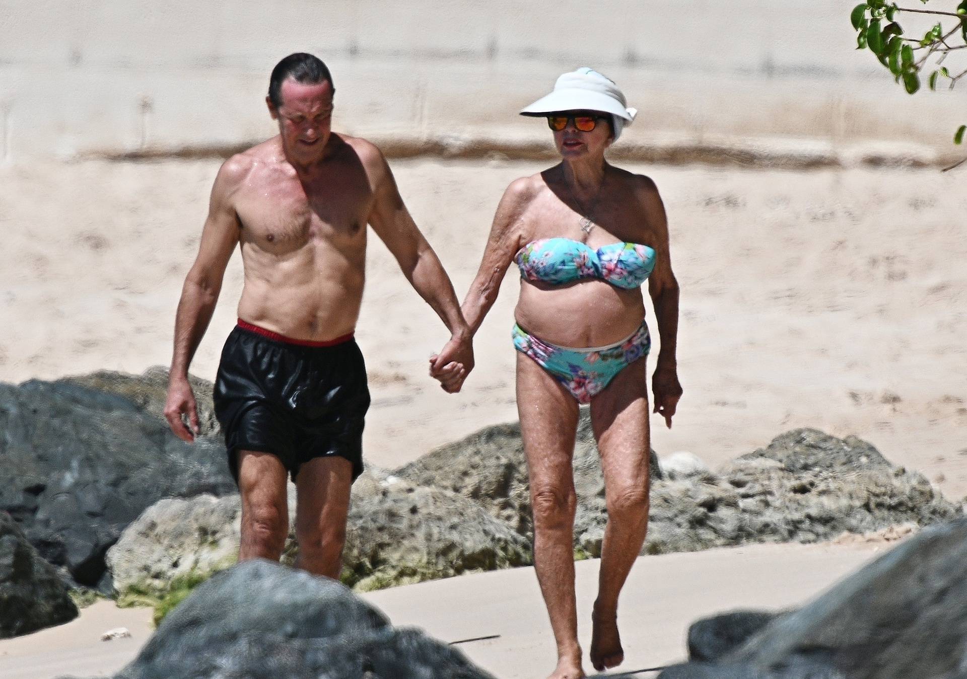 *PREMIUM-EXCLUSIVE* *MUST CALL FOR PRICING* The British Actress, 90-year-old Joan Collins and her husband Percy Gibson enjoy an affectionate stroll as they held hands at the beach on their Caribbean getaway in Western Barbados.*PICTURES TAKEN ON 31/10/20