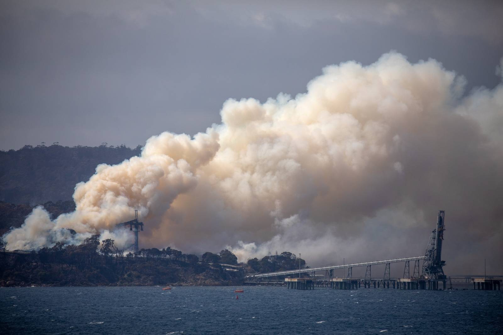 Smoke rises from the Eden Woodchip Mill, from a fire that has been blazing for days, in Eden