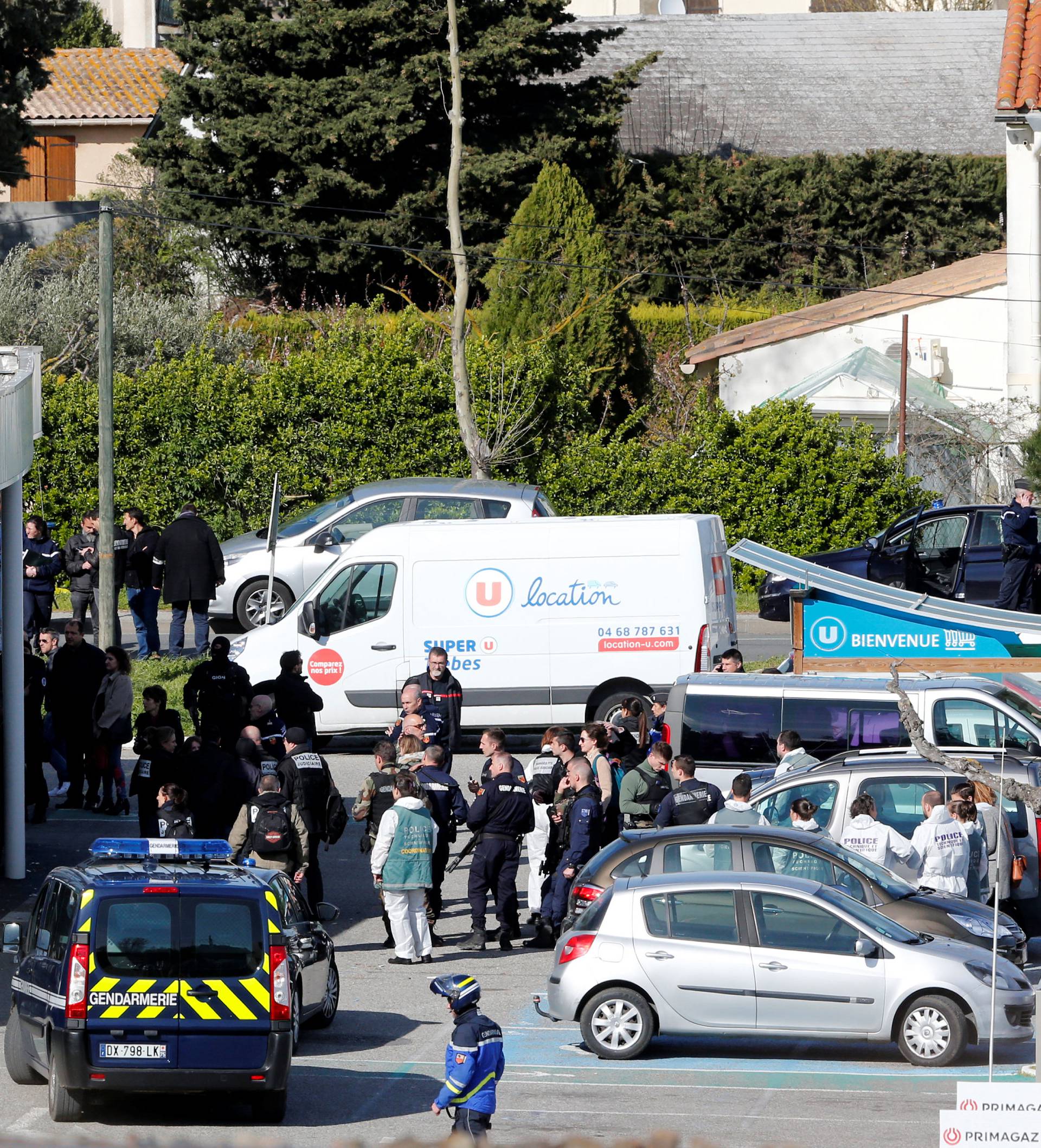 A general view shows gendarmes and police officers at a supermarket after a hostage situation in Trebes