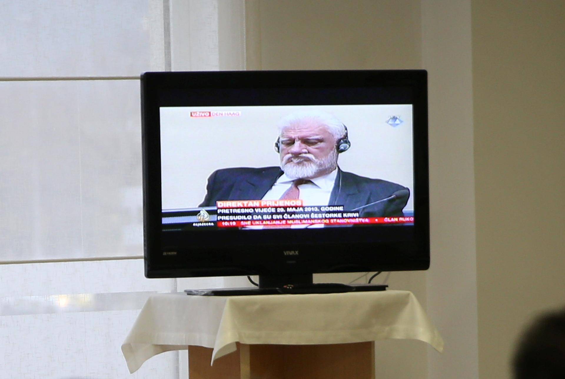 Bosnian Croat senior wartime official Praljak is seen during TV broadcast of the appeal trial in Mostar