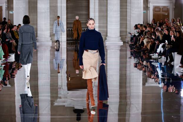 Models present creations at the Victoria Beckham catwalk show during London Fashion Week in London