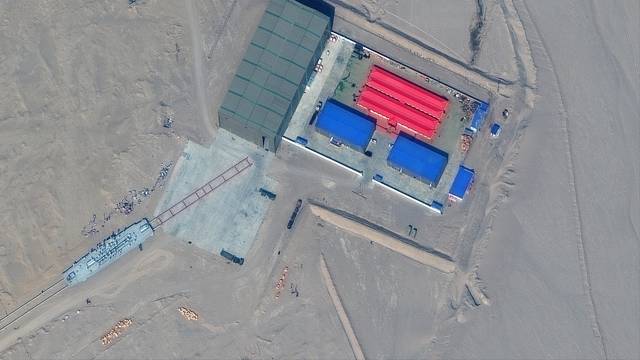 Maxar satellite image shows a rail terminus and target storage building in Ruoqiang, Xinjiang, China