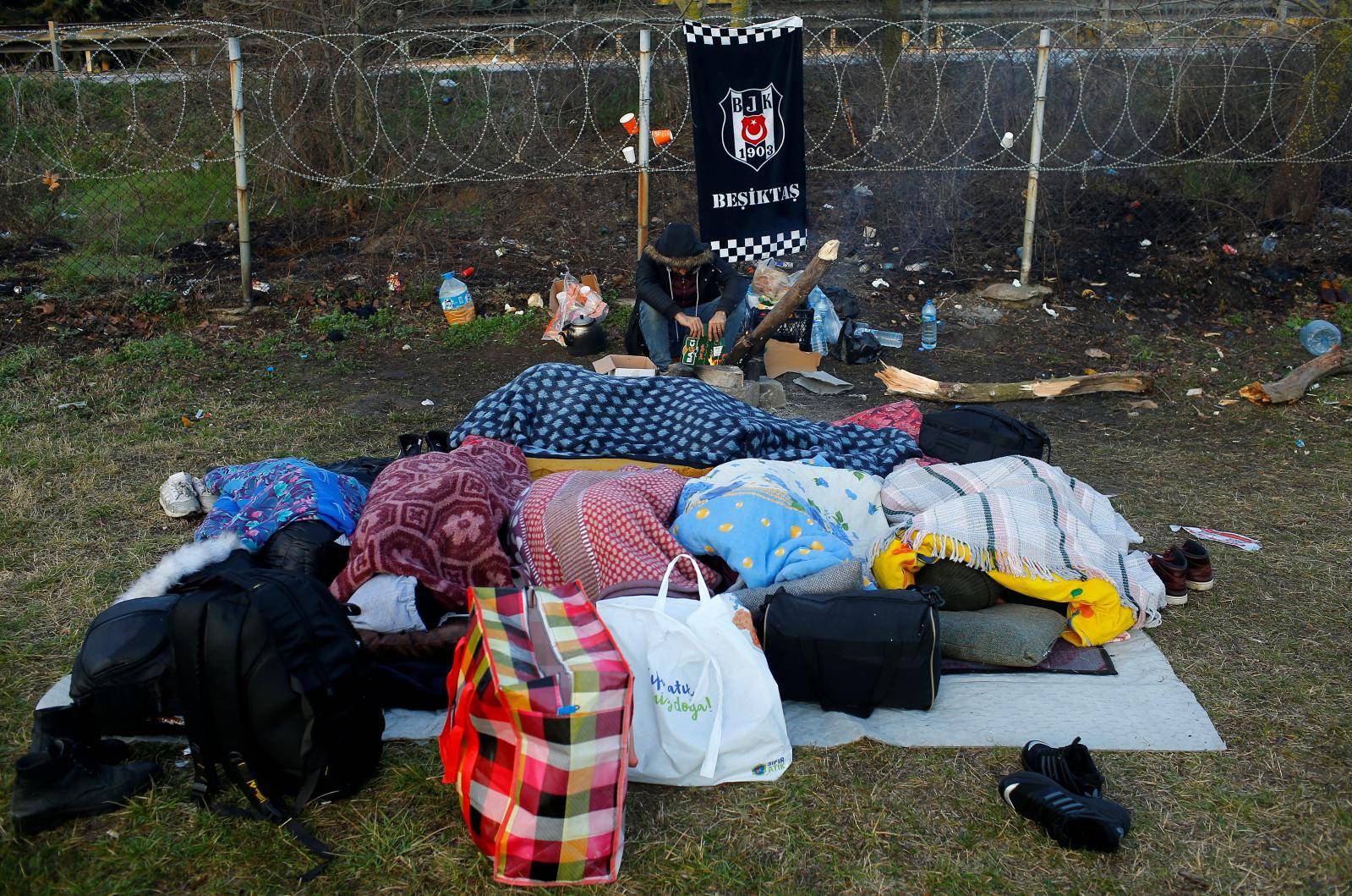 Migrants sleep near Turkey's Pazarkule border crossing with Greece's Kastanies, near Edirne