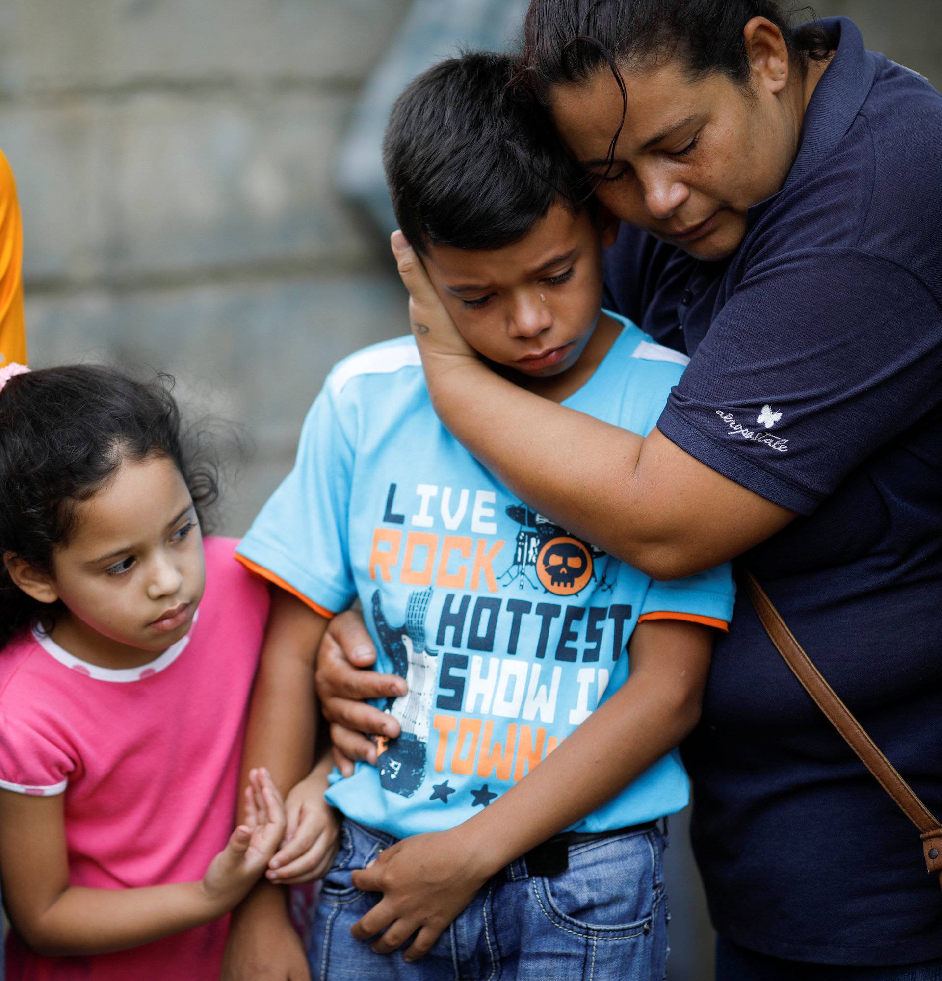 Relatives of Javier Rivas, one of the inmates who died during a riot and a fire in the cells of the General Command of the Carabobo Police, grieve during his funeral at the cemetery in Valencia