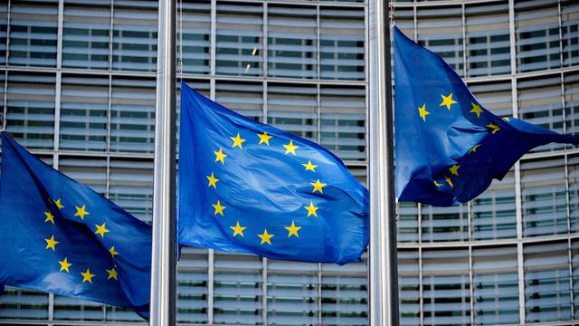 FILE PHOTO: European Union flags fly outside the European Commission headquarters in Brussels