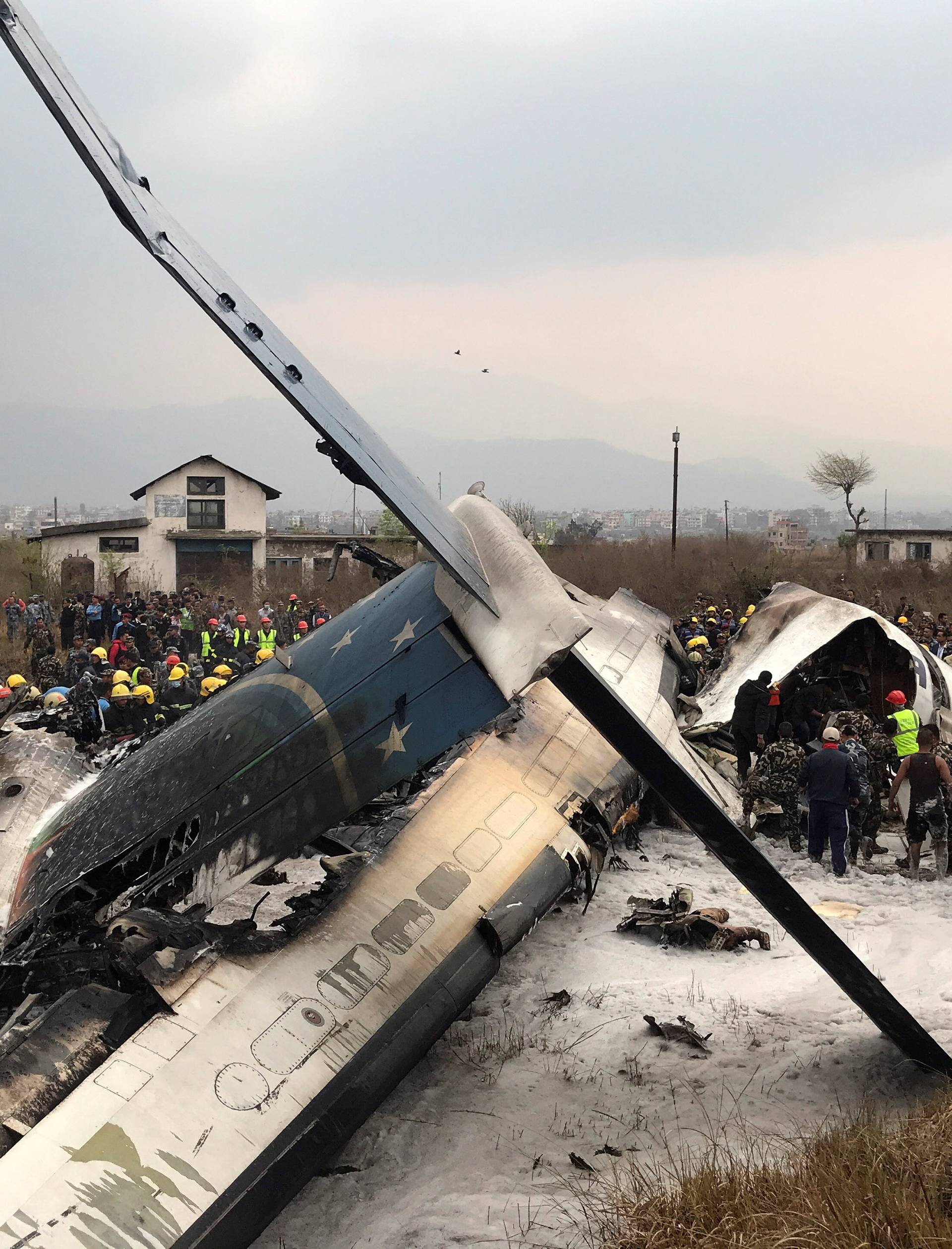 Wreckage of an airplane is pictured as rescue workers operate at Kathmandu airport