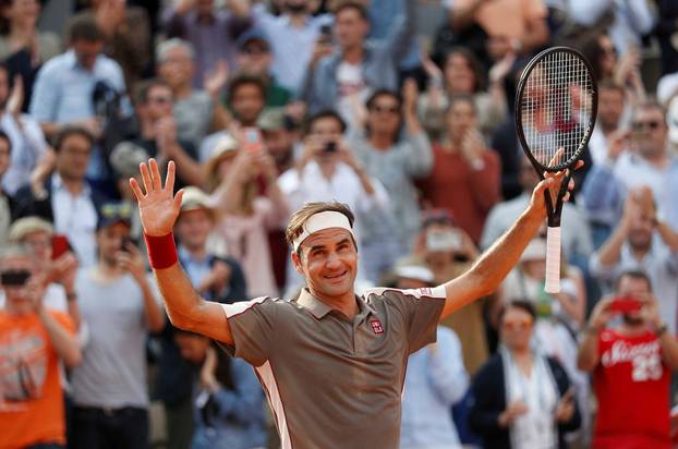 FILE PHOTO: Roger Federer celebrates after beating fellow Swiss Stan Wawrinka 7-6(4) 4-6 7-6(5) 6-4 in the quarter-finals of the French Open.