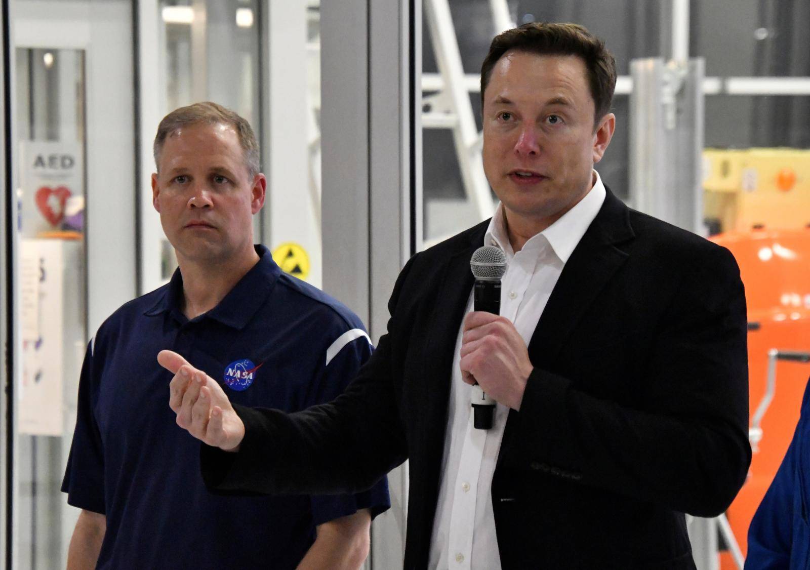 NASA Administrator Jim Bridenstine and SpaceX Chief Engineer Elon Musk talk to the press after a tour of  SpaceX headquarters in Hawthorne