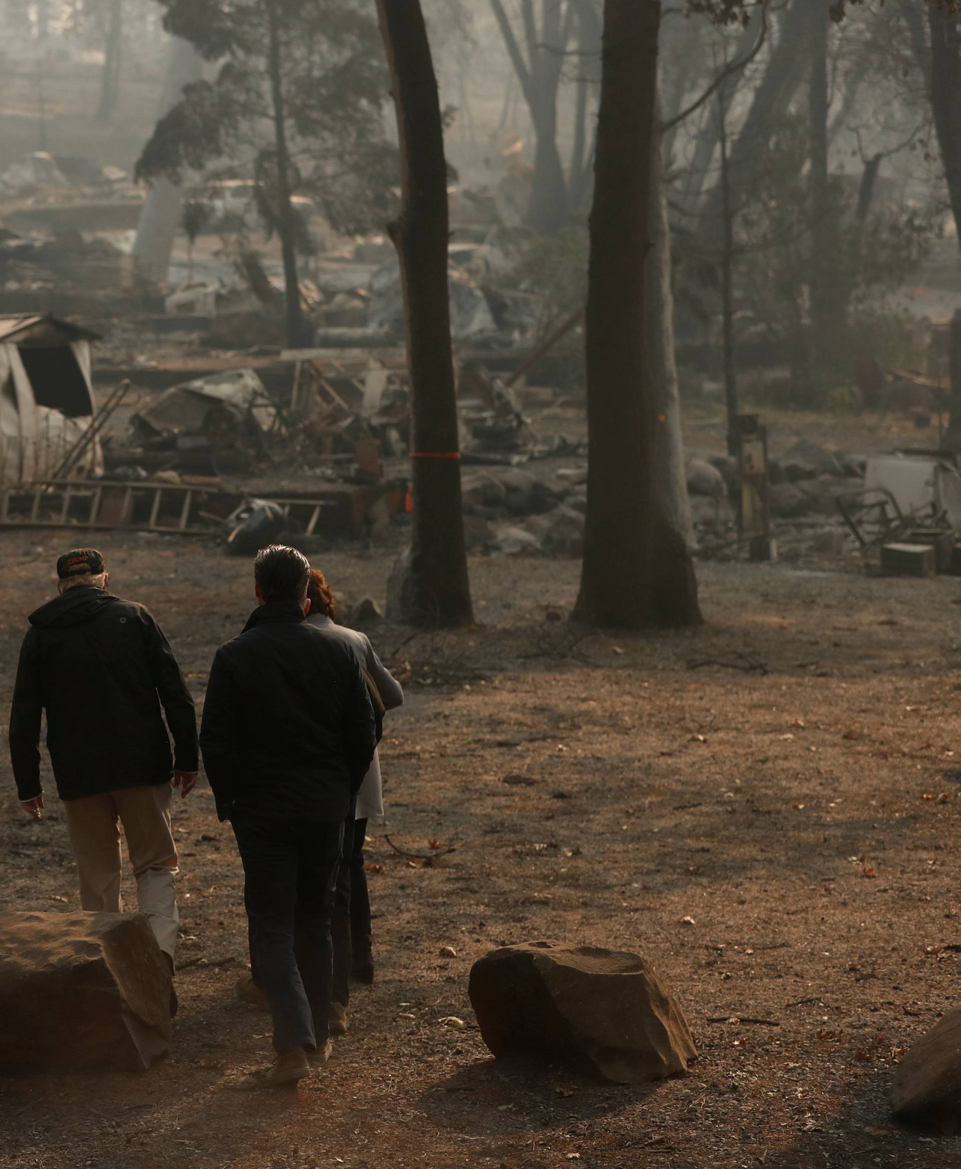 President Donald Trump visits the charred wreckage of Skyway Villa Mobile Home and RV Park with FEMA head Brock Long Paradise Mayor Jody Jones Governor-elect Gavin Newsom, and Governor Jerry Brown in Paradise California