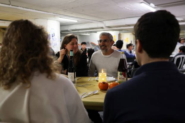 Israelis hold a Passover Seder in an underground parking garage used as a public bomb shelter, in Tel Aviv