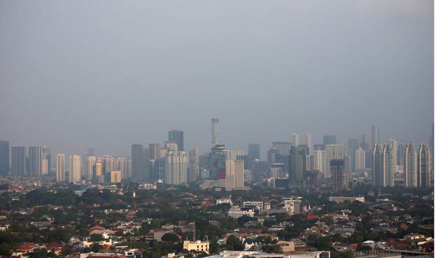 A combination picture shows a general view of high-rise buildings in Jakarta