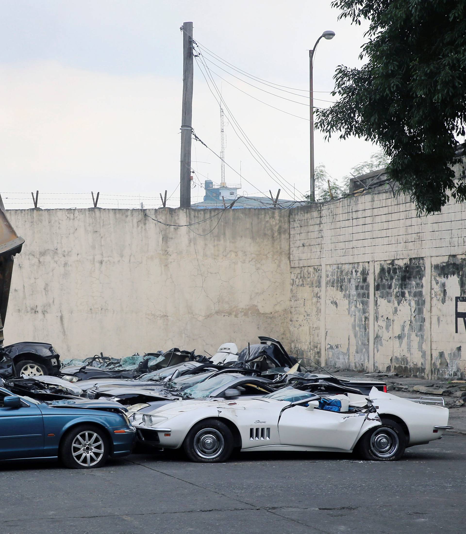 A bulldozer destroys condemned smuggled luxury cars worth 61,626,000.00 pesos during the 116th Bureau of Customs founding anniversary in Manila