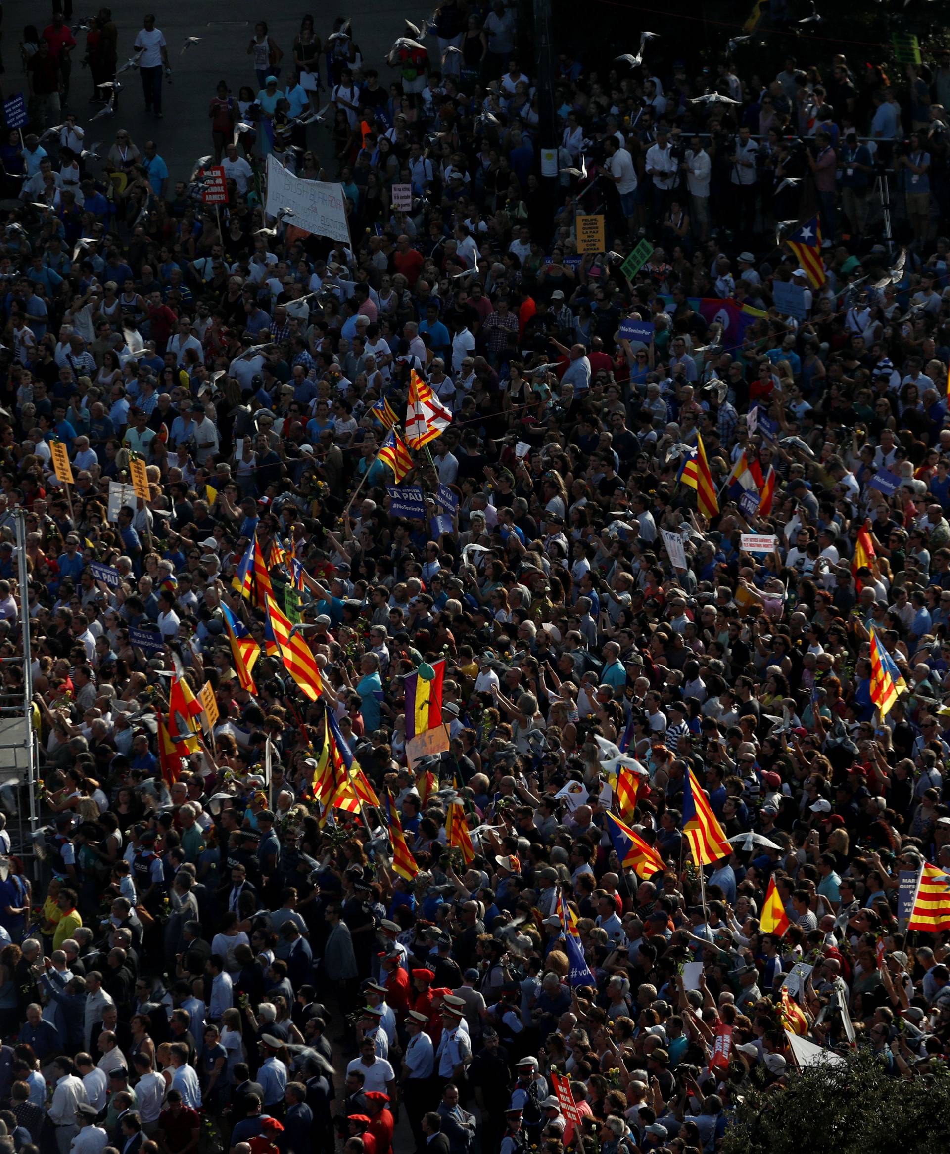 People gather at Plaza Catalunya as they take part in a march of unity after the attacks last week, in Barcelona, Spain