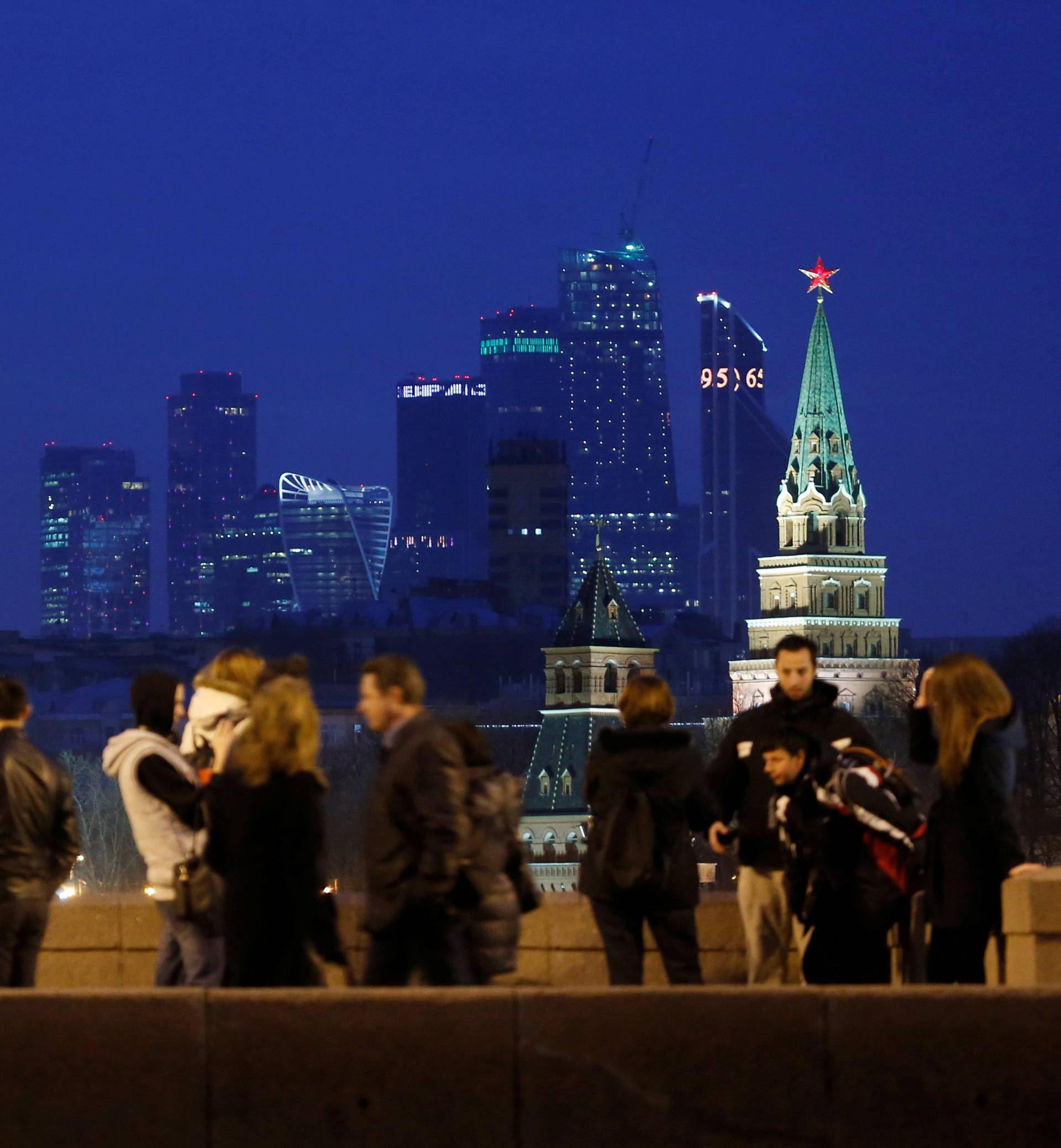 People stand on Great Moskvoretsky Bridge in central Moscow