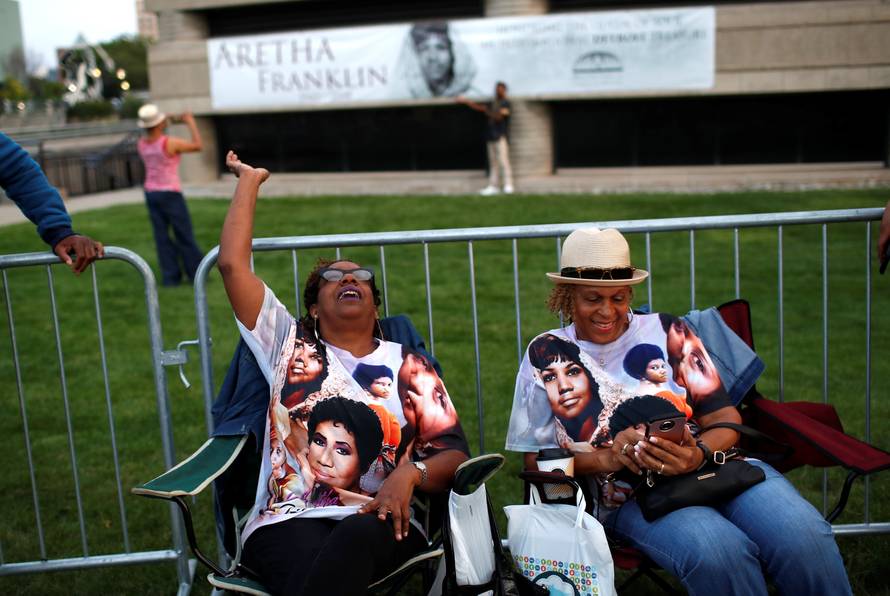 People wait in line outside the Charles H. Wright Museum of African American History where the late singer Aretha Franklin will lie in state in Detroit