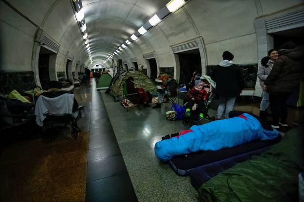 People take shelter inside a metro station during a Russian missile and drone attack in Kyiv